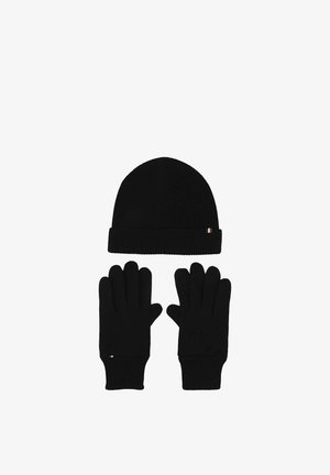 Black knit winter hat and matching gloves displayed on a white background with small rectangular tags on each item.