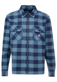 Camicia a quadri blu con zip anteriore, due tasche sul petto con pattina e un'etichetta del marchio sulla tasca sinistra. Realizzata in cotone, con maniche lunghe.