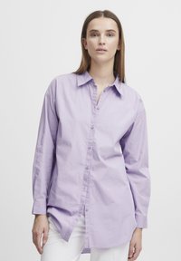 Light purple button-up shirt made of smooth cotton fabric; features a collar, long sleeves, and a relaxed fit with a straight hem.