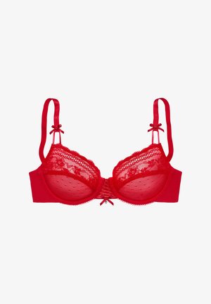 Red lace bra with semi-sheer cups, underwire support, adjustable straps, and a central bow detail. Polka dot pattern on mesh.