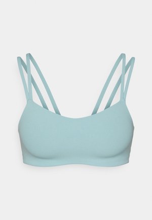 Bralet de un albastru deschis, cu o textură netedă, având patru bretele subțiri și un decolteu rotund simplu. Fără căptușeală sau embellishments.