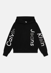 Felpa nera in cotone con maniche lunghe. Ampio testo bianco "Calvin Klein Jeans" stampato verticalmente lungo entrambe le maniche.