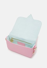 Small pink handbag with light blue suede interior, open flap, and inner zippered pocket with gold-tone zipper pull and hardware.