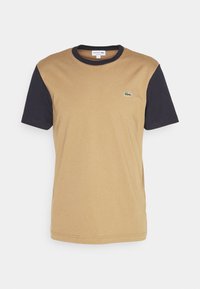 Short-sleeve t-shirt with a beige body and navy blue sleeves, made of cotton, featuring a small green crocodile logo on the chest.