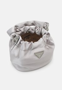 Grey satin drawstring bag with a gathered design, silver hardware, and a triangular logo plate. Soft texture and rounded shape.