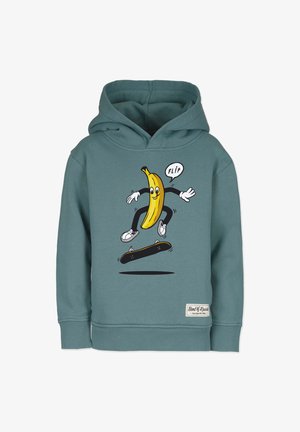 Teal huppari, jossa on piirretystä banaanista, joka skeittaa, valkoiset käsineet ja kengät. Yllä teksti "FLIP" ja brändilogo alahelassa.