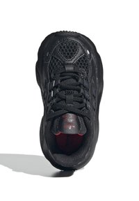 Black athletic shoe with a mesh upper, lace closure, padded collar, and a textured sole. Features a red accent inside.
