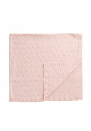 Light pink knitted blanket featuring a textured pattern of small raised dots, with a hemmed edge and a folded corner revealing the underside.