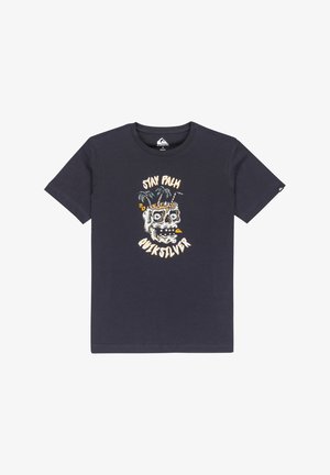 T-shirt en coton bleu marine avec un design graphique représentant un crâne et des palmiers. Le texte indique « STAY PALM » et « QUIKSILVER » en dessous de l'image.