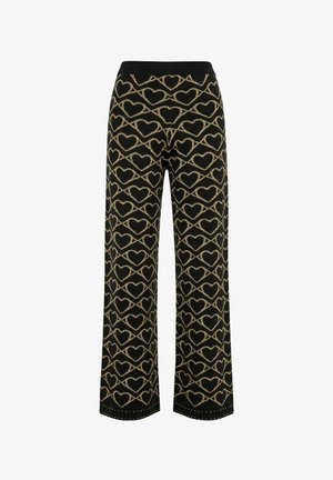 Pantalones negros de pierna ancha con patrones de corazones dorados y líneas diagonales, y cintura elástica negra.