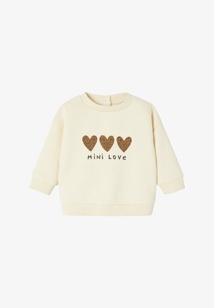 Cremefarbener Pullover mit drei Leopardenmuster-Herzen und dem Text "Mini Love". Mit weitem Ärmel und gerippten Bündchen. Weicher Stoff.