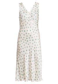 Robe florale en crème avec un décolleté en V et sans manches. Présente des motifs floraux verts et violets sur l'ensemble. Tissu lisse et léger.