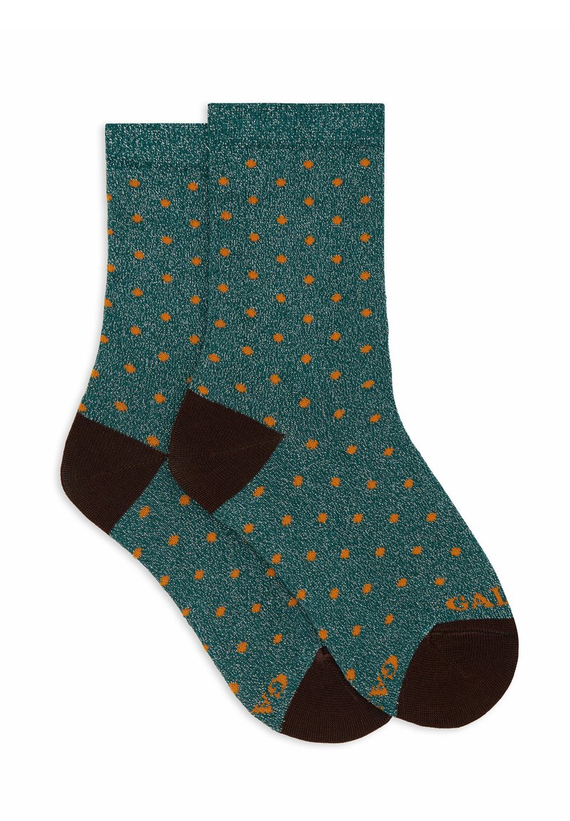 Teal socks featuring a polka dot pattern in orange, with contrasting brown cuffs and toe sections. Made from a soft, textured material.