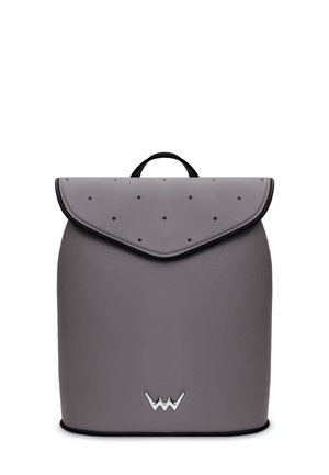 Gray leather backpack with a rounded shape, fold-over flap, and black polka dot texture. Features a top handle and silver hardware accent.