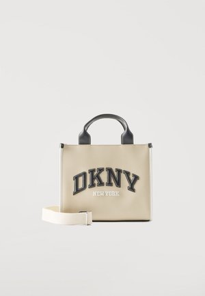 Beežist ristkülikukujuline käekott mustade käepidemetega, eemaldatava valge õlarihmaga ja esiküljel "DKNY New York" logo.