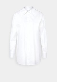 Hvid skjorte med lange ærmer, oversized krave, knaplukning foran og slidser i siderne. Fremstillet af glat stof med et klassisk design.