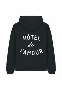 Felpa nera con testo bianco "HÔTEL de l'AMOUR" stampato sul retro in un layout curvo, dotata di maniche lunghe e cappuccio frontale.