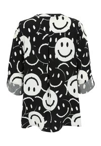 Black blouse featuring a smiling face pattern in white, with rolled sleeves and a loose fit. Lightweight fabric with a smooth texture.