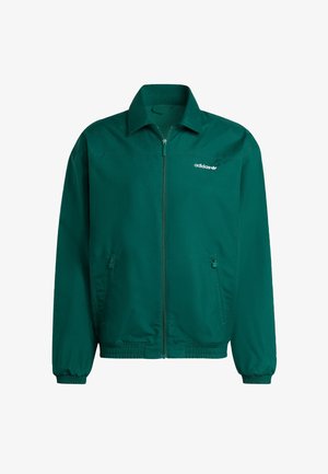 Zelena lagana jakna na zip od sintetičkog materijala. Ima ovratnik, elastične manžetne i dva bočna džepa. Prisutno je Adidasovo logo.