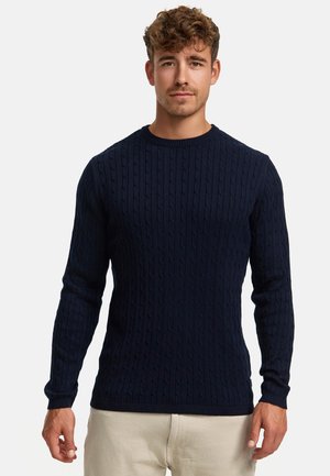 Jersey de punto azul marino con patrón de trenzas, mangas largas y cuello y dobladillo acanalados. Fabricado con un tejido suave, que ofrece una apariencia texturizada.