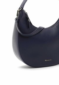 Granatowa skórzana torebka o zaokrąglonym kształcie, gładkiej fakturze i prostej stylistyce. Posiada pasek na ramię oraz złote logo jako detal.