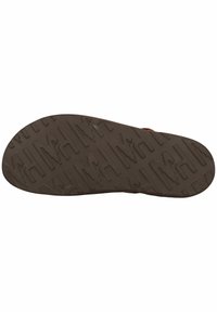 Brun gummisula med en texturerad, mönstrad yta med djupa spår och upphöjda inslag för bättre grepp.