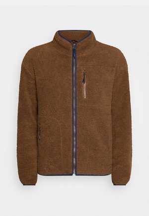 Brun fleecejakke med høy krage, full frontglidelås og marineblå detaljer. Har to sidelommer og en brystlomme med glidelåsdetalj.