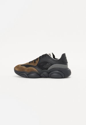 Black and brown sneaker featuring a mix of suede and mesh materials, rounded silhouette, contrasting textures, and thick, rounded sole.