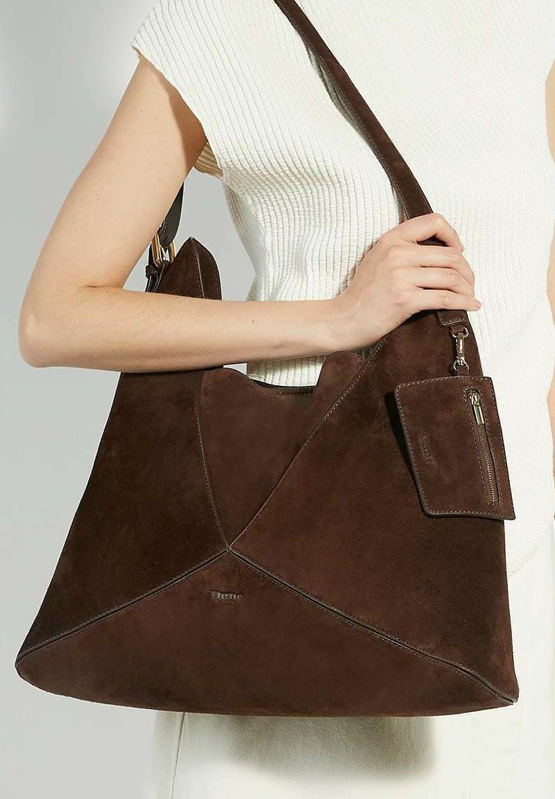 Brown suede tote bag with angular design and a detachable zippered pouch. Features a single shoulder strap and embossed brand logo.