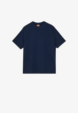 T-shirt blu navy a maniche corte con scollo a girocollo e una piccola etichetta marrone all'interno del colletto su sfondo bianco.