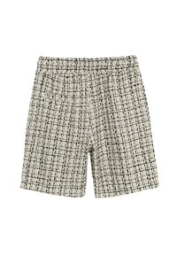 Shorts en tweed crème avec motif vichy noir, taille élastique et poches latérales. Le tissu texturé ajoute un intérêt visuel.