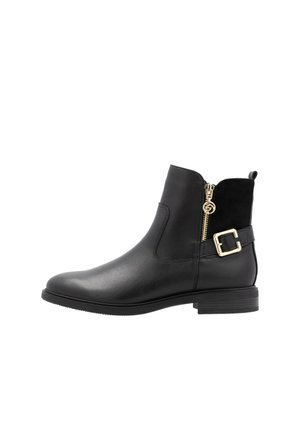 Bottillon noir en cuir lisse et en suède, avec une fermeture éclair dorée, un accent en boucle et une semelle plate. Silhouette classique avec une finition texturée.