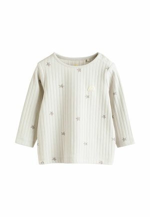 Vaaleanharmaa pitkähihainen paita, jossa on ribbikuvio ja tummemmasta sävystä koostuvia tähkäkuvioita. Kauluksen lähellä on pieni sateenkaariembroidery.