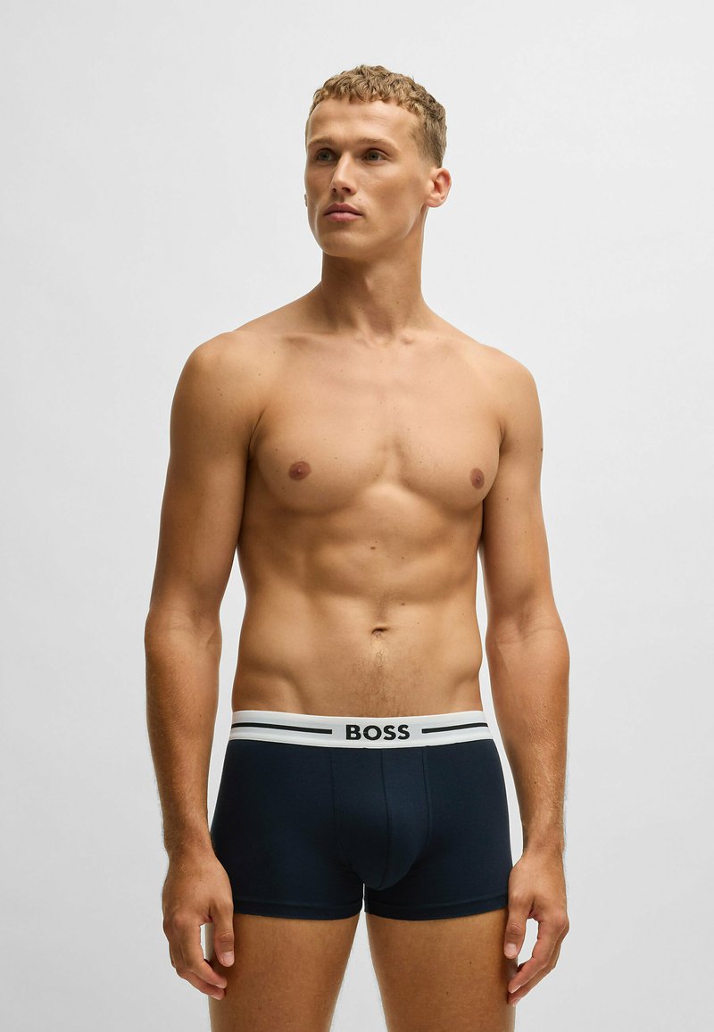 Navy boxer briefs made from soft fabric, featuring a white elastic waistband with "BOSS" logo. Designed with a fitted, supportive cut.
