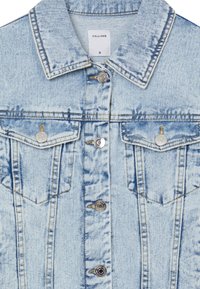 Light blue denim jacket with a classic collar, front button closure, two chest pockets, and silver hardware accents. Features denim texture.