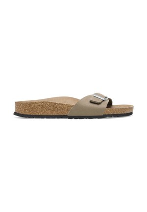 Cork footbed slide sandal with a beige suede strap, featuring a metallic buckle detail and a black rubber outsole for grip.