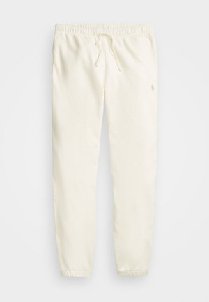 White jogger pants made of soft fabric, featuring an elastic waistband with a drawstring and ribbed cuffs. Subtle logo near the hip.