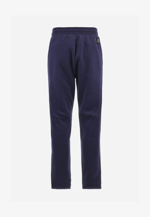 Pantalones jogger azul marino hechos de una tela suave, con cintura elástica, puños ajustados y una pequeña etiqueta de logo en la parte trasera.