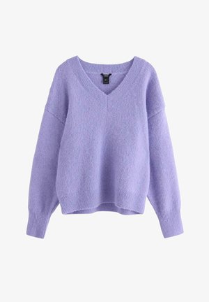Lila V-ringad tröja i mjukt, strukturerat material med avslappnad passform, sänkta axlar och ribbade ärmslut och avslut.