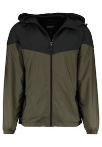 Lightweight jacket features a black hood and upper section, with an olive green lower half. Zipper front, elastic cuffs, and two side pockets.