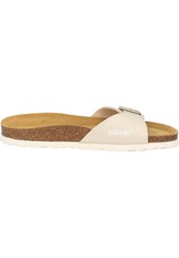Beige slidesandal med en korkfotbädd, ett slätt övre rem med en metallspänne och en strukturerad yttersula. Varumärkeslogotyp tryckt på sidan.