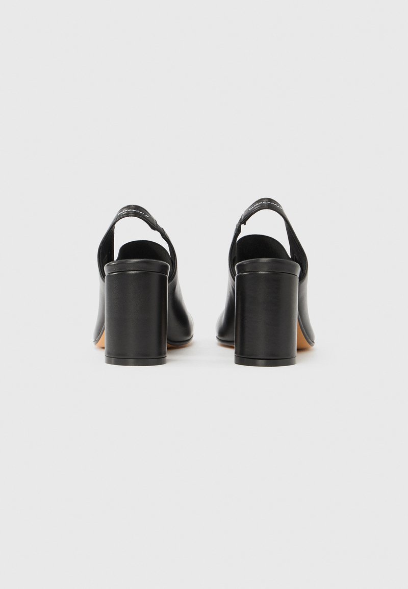 Sorte læder sko med hæl og slingback-design, firkantet tå og blokhæl. Glat tekstur med diskrete syningsdetaljer.