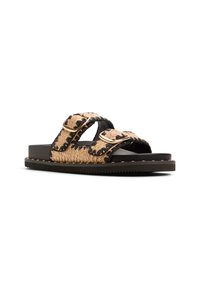 Sandals with two adjustable straps made of woven tan material, outlined in black, featuring gold-tone buckles and a black sole with studs.