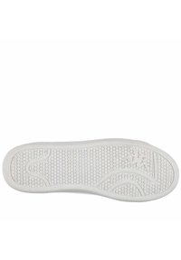 Suola di scarpa in gomma bianca con motivo strutturato a grip circolari, bordi lisci e un logo discreto vicino all'area del tallone.