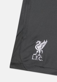 Schwarzes Sportshirt mit strukturierter Oberfläche, versehen mit weiß gesticktem Liverpool FC-Logo und dem Schriftzug "L.F.C." in der unteren Ecke.