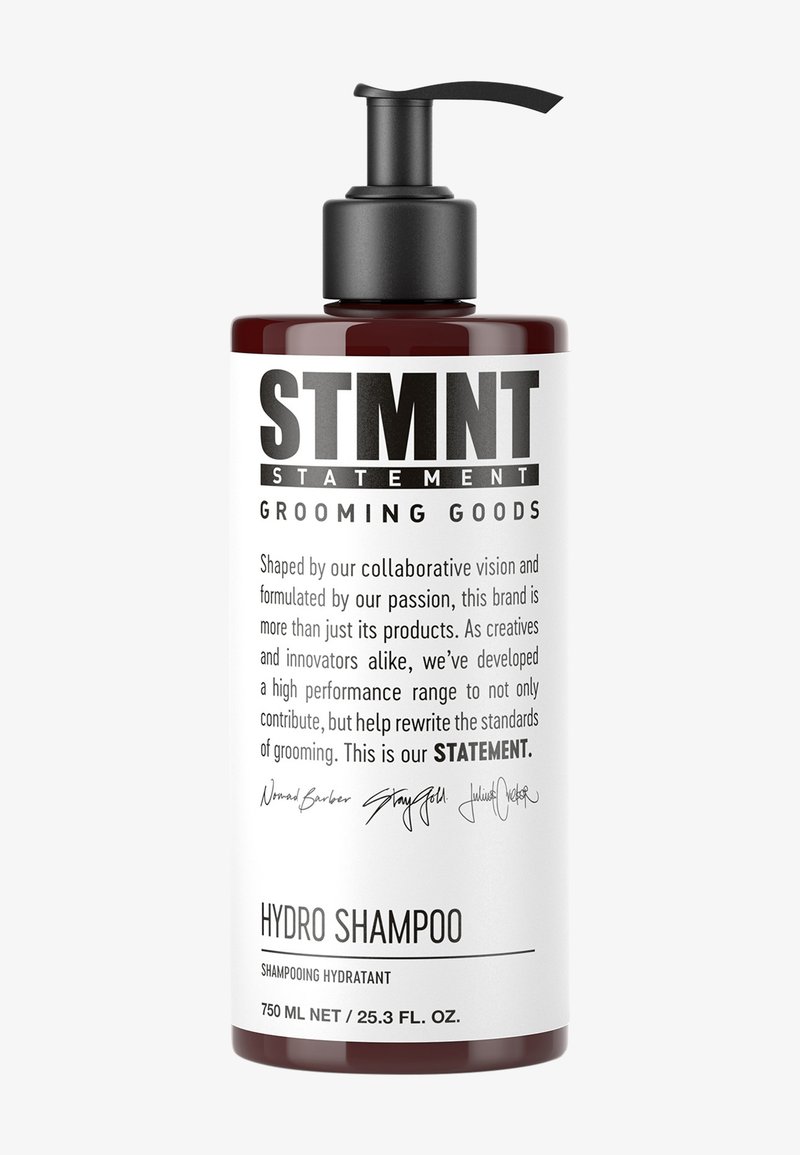 Dunkelbernfarbene Kunststoffflasche mit schwarzem Pumpspender. Weißes Etikett mit fettem Text und detaillierter Beschreibung. Enthält 750 ml Hydro-Shampoo.