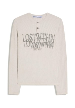 Bézs színű bordázott, hosszú ujjú henley póló három gombbal és a mellkason átfedő, kopott hatású "LOST WITHIN" felirattal.