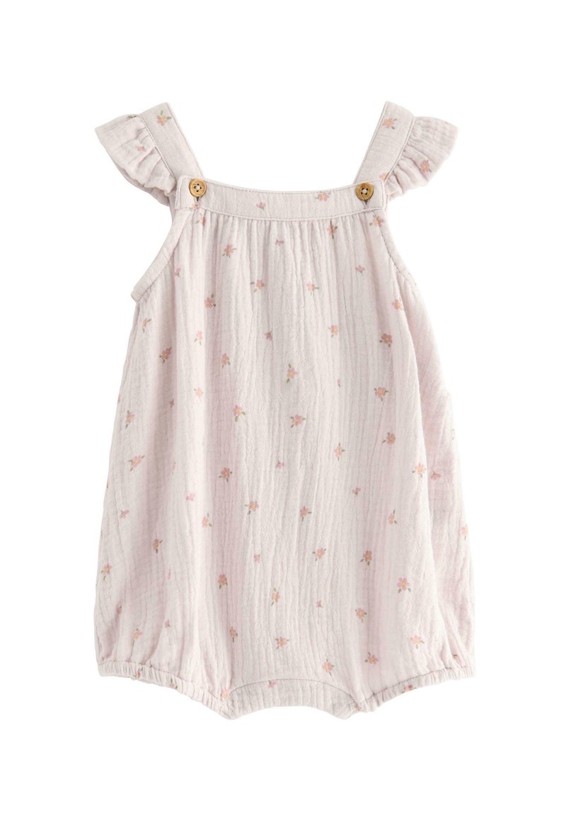 Salopette in mussola rosa chiaro con spalline arricciate, bottoni in legno e motivi floreali sparsi. Texture morbida e aperture elastiche per le gambe.