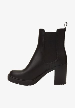 Black ankle boot made of smooth leather with elastic side panels, a thick block heel, and a textured outsole for grip.
