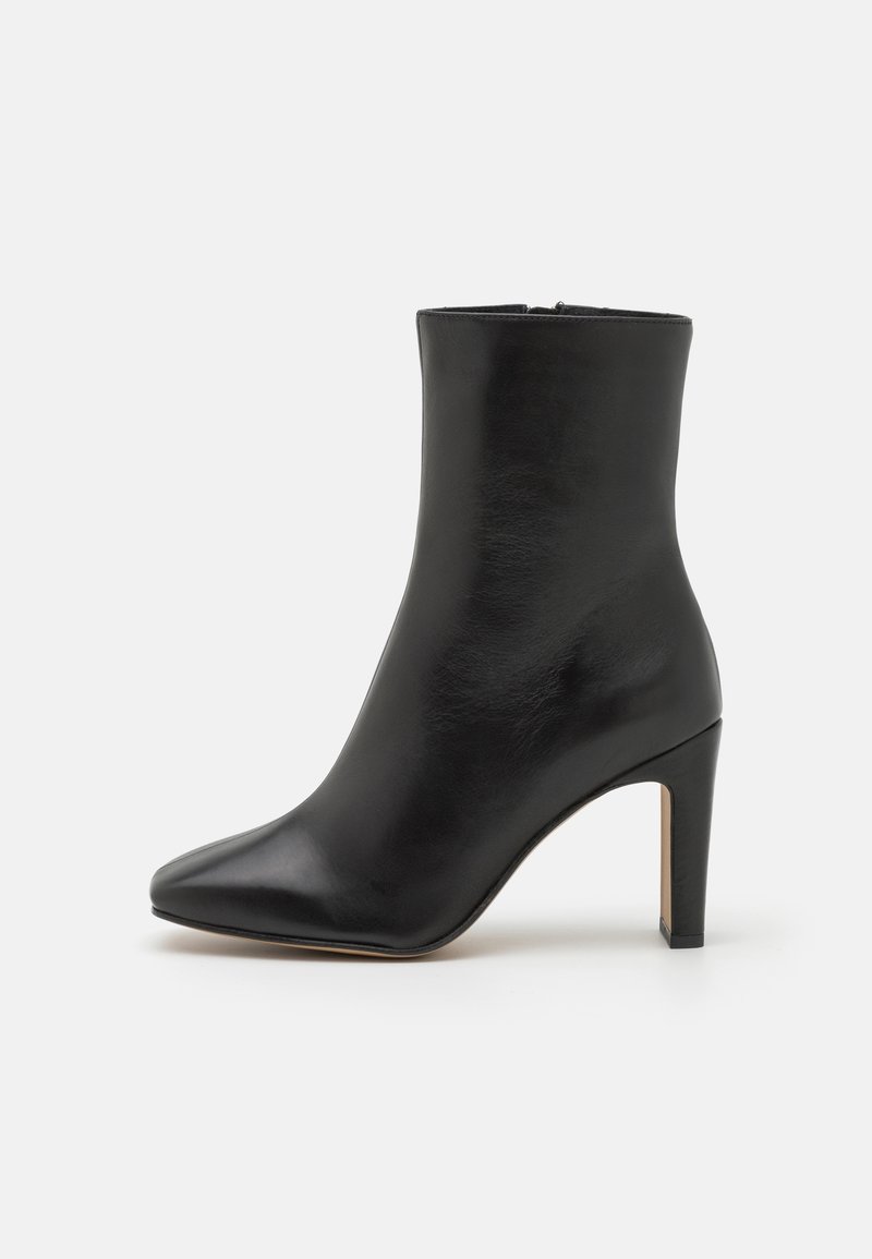 Black leather ankle boots with a pointed toe and a high stiletto heel, featuring a smooth texture and no visible hardware.